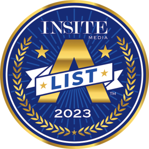 Circular badge with gold laurel leaves, stars, a large A and ribbon reading List, labeled Insite Media 2023 on a blue background.