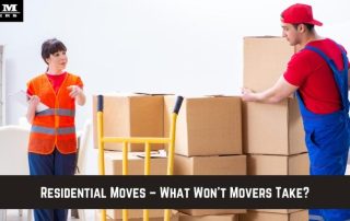 A mover in uniform stands by stacked cardboard boxes with a dolly, while a woman in a safety vest gestures and talks in a residential setting.